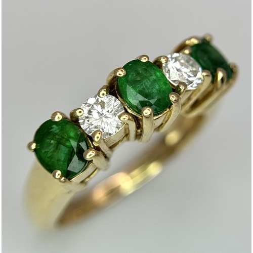 121 - A Mesmerising 14K Yellow Gold Emerald and Diamond Ring. 0.75ctw of oval cut emeralds alternate with ... 