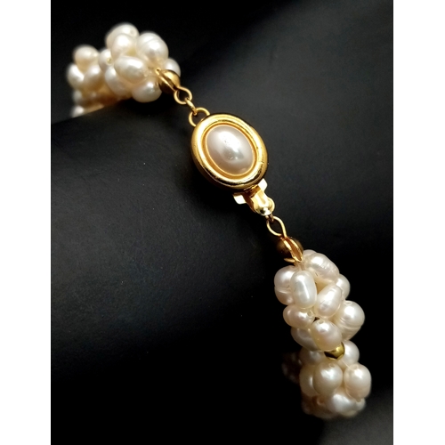 125 - A very feminine, unusual bracelet, with white cultured pearls forming eleven oval groups. Length: 19... 