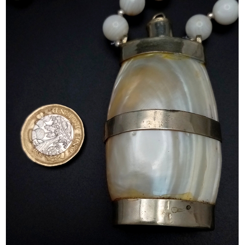 139 - A vintage mother of pearl necklace with a miniature bottle pendant to carry Holly Water as worn by p... 