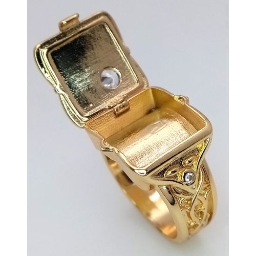 174 - An interesting gold-filled gent’s ring with a single cubic zirconium and a secret compartment for th... 