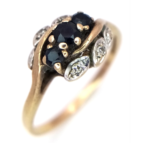 26 - A Vintage 9K Yellow Gold Diamond and Sapphire Crossover Ring. Size N 1/2. 2g.