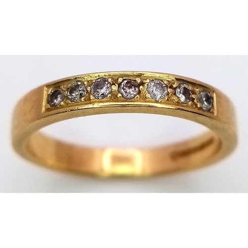 31 - An 18K Yellow Gold Seven Stone Channel Set Diamond Ring. 
Size K. 3.1g