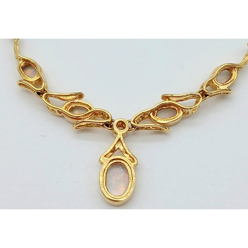 54 - A Gorgeous Italian 18K Gold and Opal Lavaliere Necklace. Five opal cabochons with excellent colour-p... 