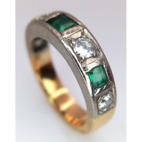 57 - An 18K Yellow Gold (tested) Diamond and Emerald Band Ring. 0.60ctw of brilliant round cut diamonds a... 