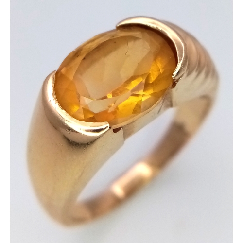 64 - A Glorious 14K Yellow Gold Citrine Oval Cut Ring. A 3ct citrine sits atop raised, ridged gold. Size ... 