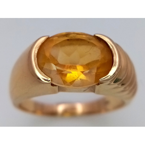 64 - A Glorious 14K Yellow Gold Citrine Oval Cut Ring. A 3ct citrine sits atop raised, ridged gold. Size ... 