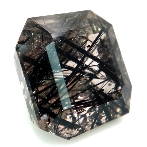 1153 - A 105.53ct Ludwigite-vonsenite quartz, step cut, colourless with black needles, origin: Pakistan. 27... 