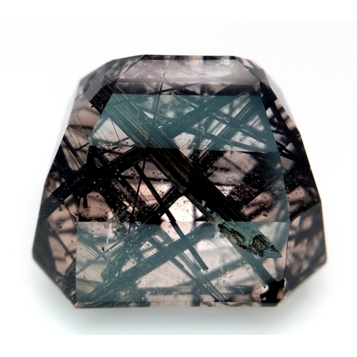 1153 - A 105.53ct Ludwigite-vonsenite quartz, step cut, colourless with black needles, origin: Pakistan. 27... 