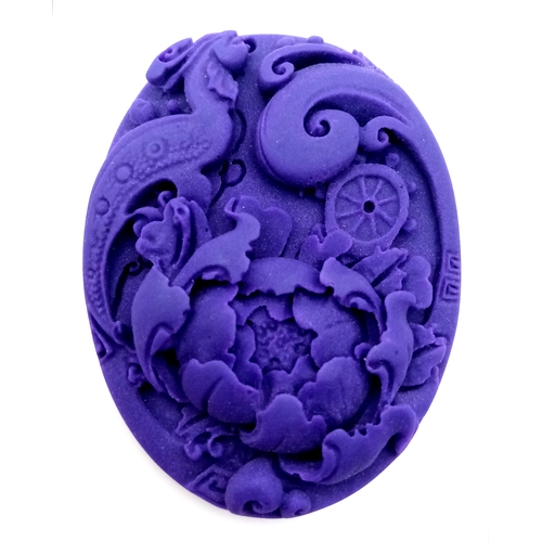 896 - An Ornate Lavender Jadeite Oval Pendant. Foliage decoration. 5.5cm.