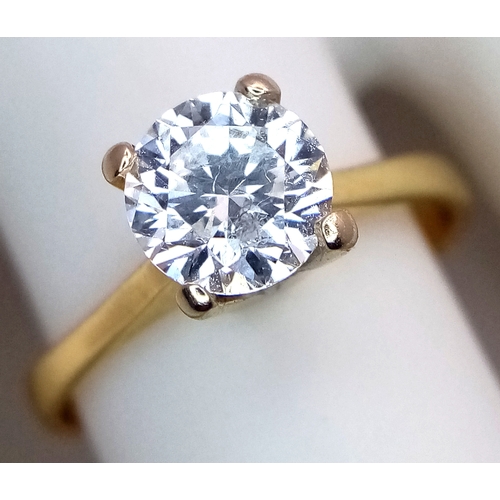 65 - A WGI Certified 18K Yellow Gold and Diamond Solitaire Ring. A 1.02ct brilliant round cut diamond. SI... 