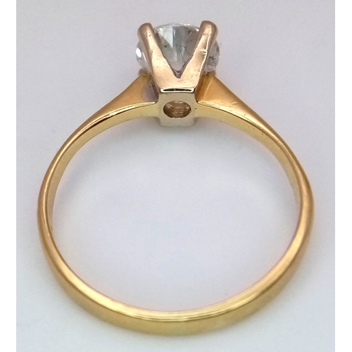 65 - A WGI Certified 18K Yellow Gold and Diamond Solitaire Ring. A 1.02ct brilliant round cut diamond. SI... 