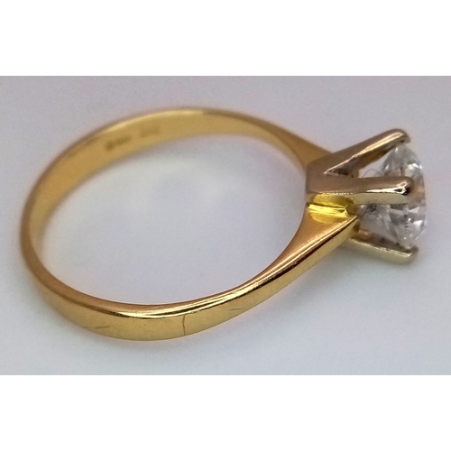 65 - A WGI Certified 18K Yellow Gold and Diamond Solitaire Ring. A 1.02ct brilliant round cut diamond. SI... 