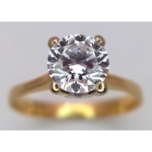 65 - A WGI Certified 18K Yellow Gold and Diamond Solitaire Ring. A 1.02ct brilliant round cut diamond. SI... 