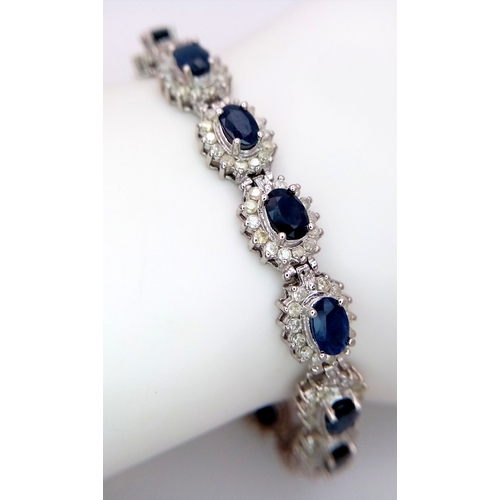 663 - A Beautiful 14K White Gold, Sapphire and Diamond Bracelet. Seventeen oval cut sapphires each with a ... 