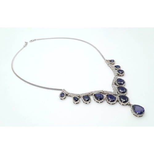 337 - A Blue Sapphire and Diamond Necklace. Set in 925 Silver. Pear shaped sapphires -20ctw approx with Di... 