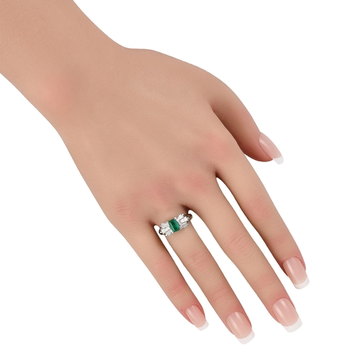 994 - A Platinum 1.07ct Diamond and Emerald Ring. The Platinum setting beautifully showcases this pieces r... 