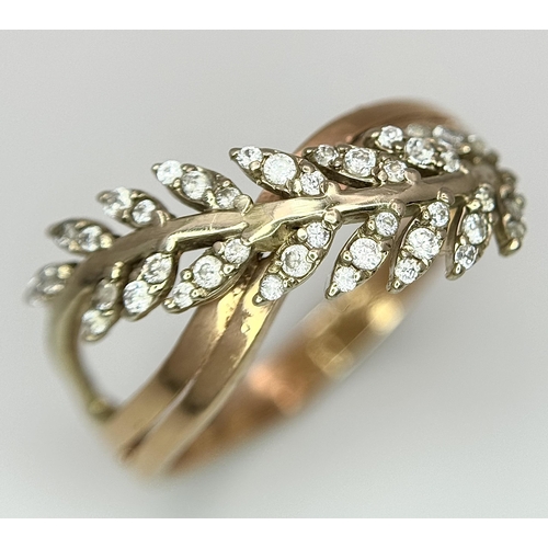 260 - An 18K Yellow Gold Diamond Leaf Form Crossover Ring. Size O 1/2. 3.2g