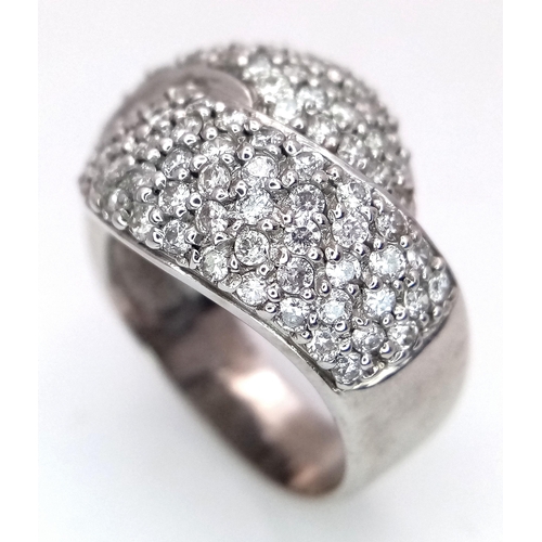 379 - An 18K White Gold Diamond Crossover Pave Ring. Size M. 7.25g total weight.