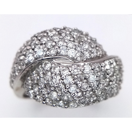 379 - An 18K White Gold Diamond Crossover Pave Ring. Size M. 7.25g total weight.