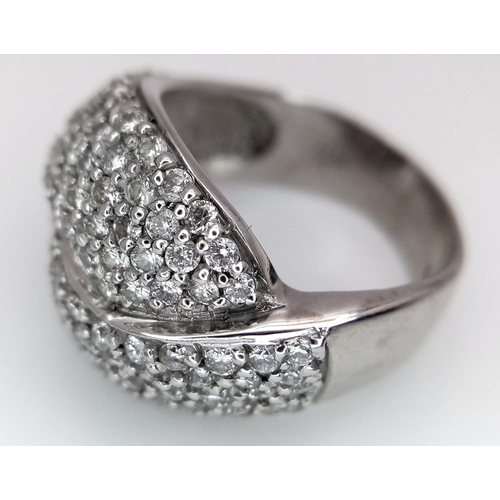 379 - An 18K White Gold Diamond Crossover Pave Ring. Size M. 7.25g total weight.