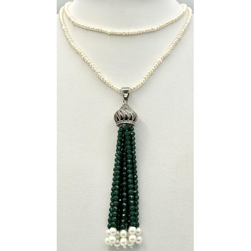 386 - A Cultured Seed Pearl Necklace with Jade Bead Tassel Pendant. Decorative silver attachment. 8cm and ... 