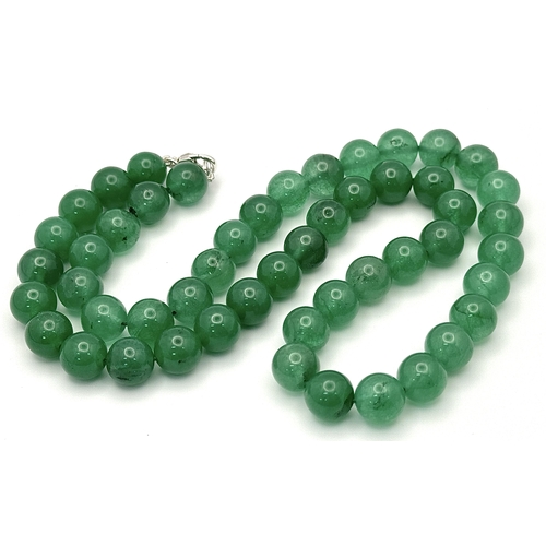 505 - A Jade Beaded Necklace with Silver Clasp. 48cm