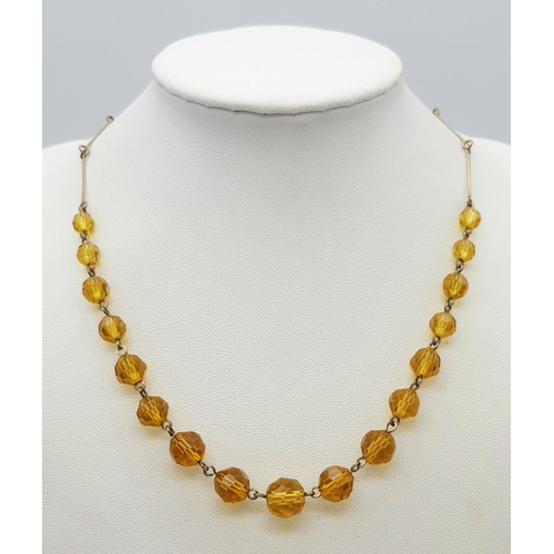 1016 - An Art Deco Gold Plated and Topaz Paste Necklace. 41cm.