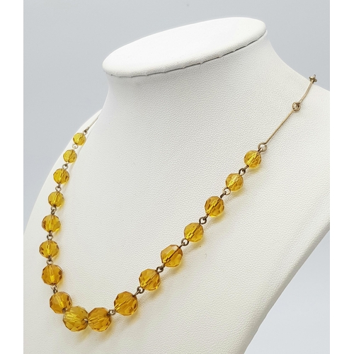 1016 - An Art Deco Gold Plated and Topaz Paste Necklace. 41cm.