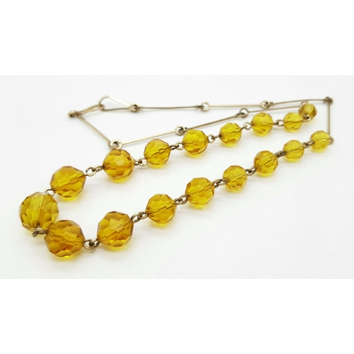 1016 - An Art Deco Gold Plated and Topaz Paste Necklace. 41cm.