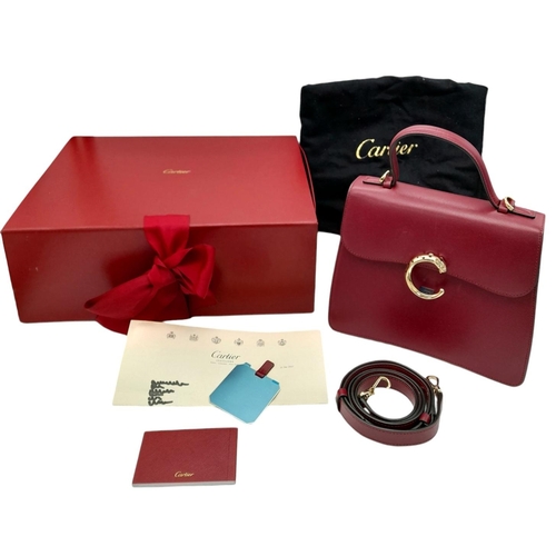 104 - A Panthère de Cartier Handbag. Crafted from poppy red calfskin leather with gold-toned hardware. Fea... 