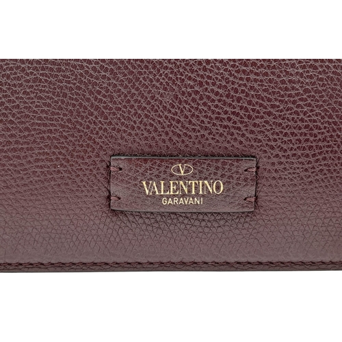 152 - A Valentino Garavani Burgundy Leather Shoulder Bag. Burgundy leather exterior with gold-toned hardwa... 