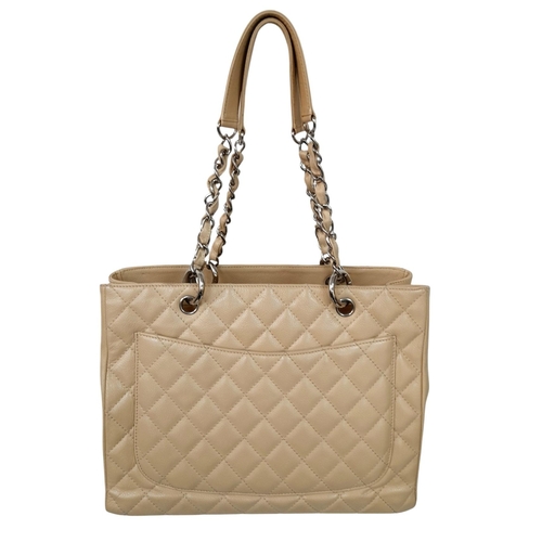 180 - A Chanel Caviar Quilted Tote Bag. Crafted from beige quilted caviar leather, featuring silver-toned ... 