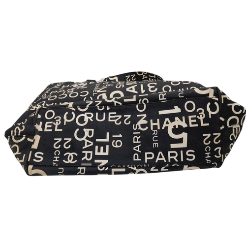 215 - A Chanel Black and Beige Rue Cambon Tote/Beach Bag. Textile exterior with silver-toned and clear res... 