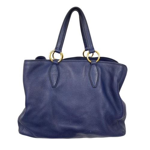 328 - A Miu Miu Vitello Caribu Top Handle Bag. Blue leather exterior with gold-toned hardware, double stra... 