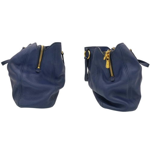 328 - A Miu Miu Vitello Caribu Top Handle Bag. Blue leather exterior with gold-toned hardware, double stra... 