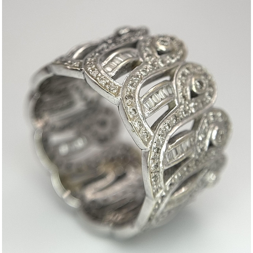 370 - An 18K White Gold and Diamond Crown Band Ring. Regal in nature with round and baguette cut diamonds ... 