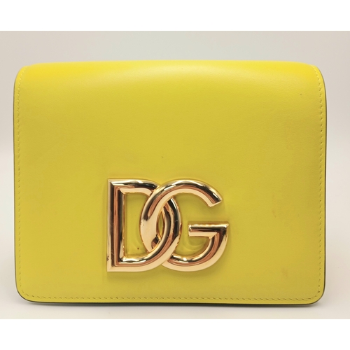 391 - A Dolce & Gabbana Crossbody Bag. Smooth yellow leather exterior with gold-toned hardware, featuring ... 