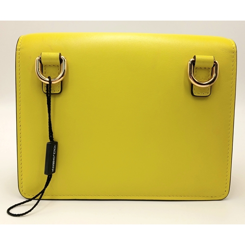 391 - A Dolce & Gabbana Crossbody Bag. Smooth yellow leather exterior with gold-toned hardware, featuring ... 