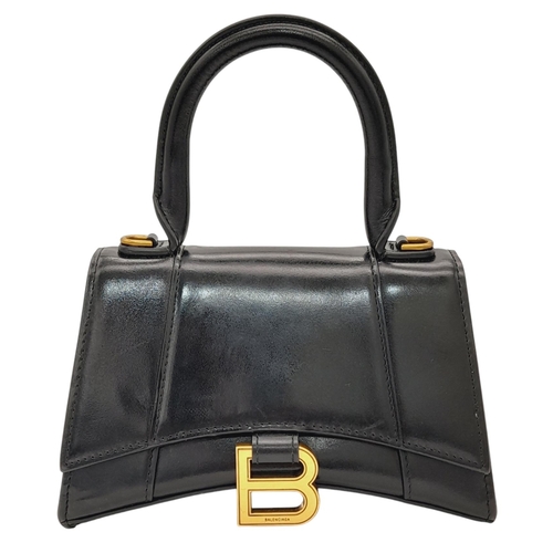 462 - A Balenciaga Hourglass Top Handle Bag. Black leather exterior with gold-toned hardware, featuring a ... 