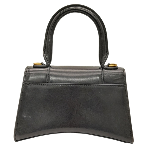 462 - A Balenciaga Hourglass Top Handle Bag. Black leather exterior with gold-toned hardware, featuring a ... 