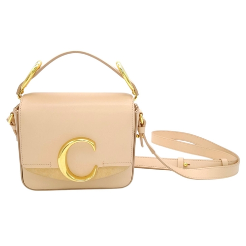 476 - A Chloé Pink C Crossbody Bag. Pink calf leather exterior with a beige suede panel near the gold-tone... 