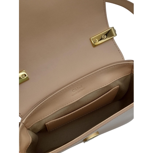 476 - A Chloé Pink C Crossbody Bag. Pink calf leather exterior with a beige suede panel near the gold-tone... 