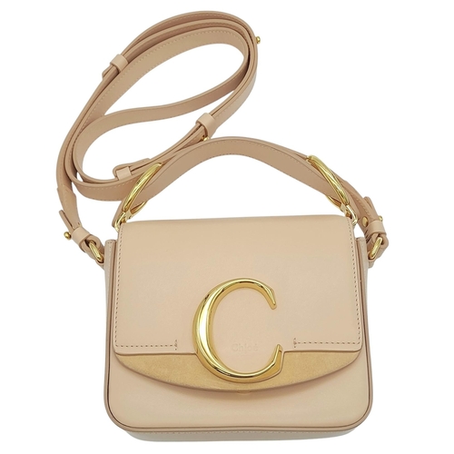 476 - A Chloé Pink C Crossbody Bag. Pink calf leather exterior with a beige suede panel near the gold-tone... 