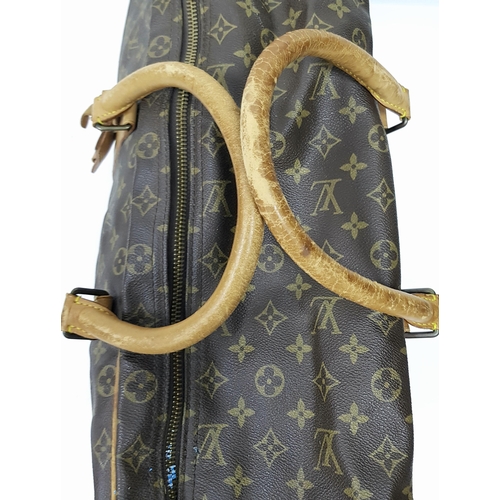 497 - A Louis Vuitton Sirius 70 Travel Bag. Monogram coated canvas exterior with leather trim, two rolled ... 