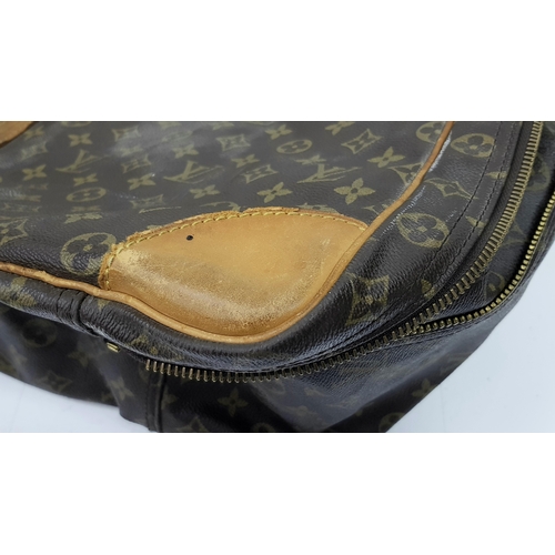 497 - A Louis Vuitton Sirius 70 Travel Bag. Monogram coated canvas exterior with leather trim, two rolled ... 