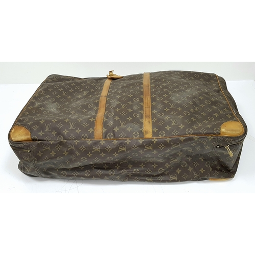 497 - A Louis Vuitton Sirius 70 Travel Bag. Monogram coated canvas exterior with leather trim, two rolled ... 