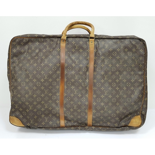 497 - A Louis Vuitton Sirius 70 Travel Bag. Monogram coated canvas exterior with leather trim, two rolled ... 