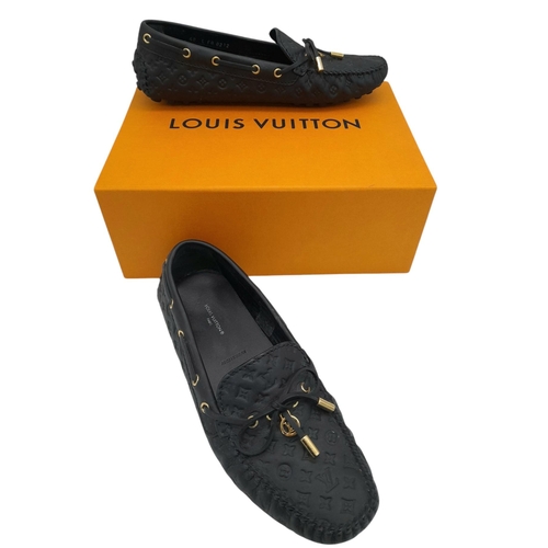 559 - A pair of Louis Vuitton Empreinte Gloria Loafers. Made from black leather with embossed LV monogram,... 