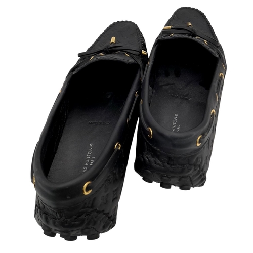 559 - A pair of Louis Vuitton Empreinte Gloria Loafers. Made from black leather with embossed LV monogram,... 