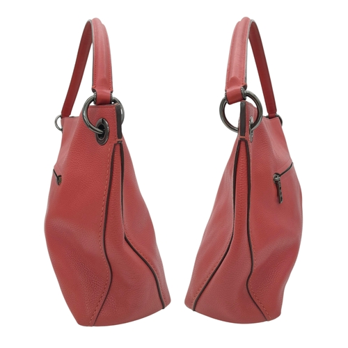 636 - A Coach Coral Clarkson Hobo Bag. Pebbled leather exterior with chrome-toned hardware, zipped compart... 